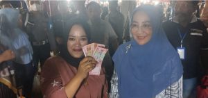 Caption foto : Dagang buah lai milik Nursana, kiri, diborong Bupati Berau, Sri Juniarsih, kanan, di akhir Hut ke-13 Pandawa Centre, lapangan pemuda, Tanjung redeb, Berau, Minggu malam, 28/5/2023, Foto: (Sulkifli)